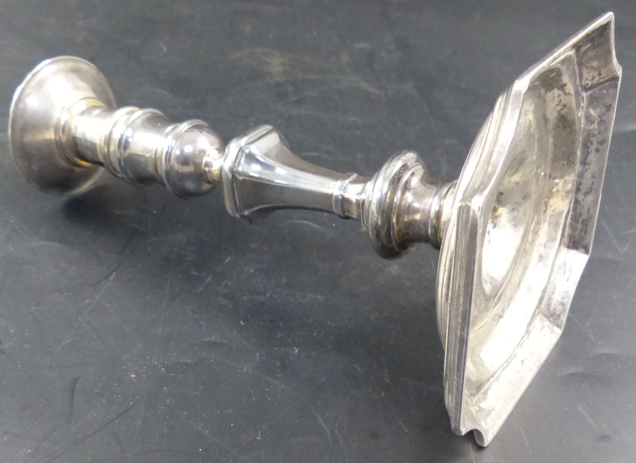 A George II cast silver candlestick by Abraham Buteux, London, circa, 1725, 14.7cm, 11oz.